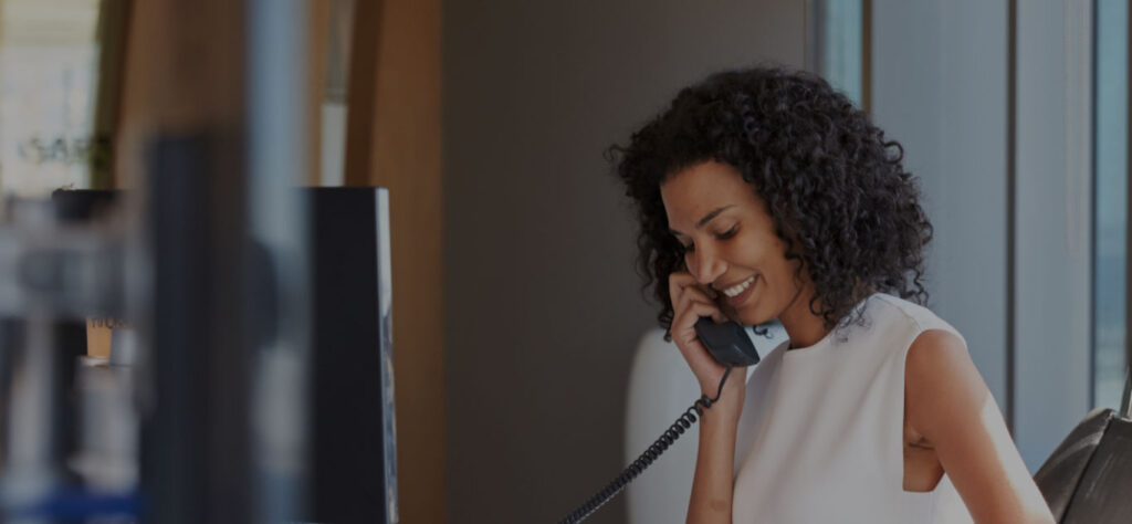 Image of office worker using internet based phone system